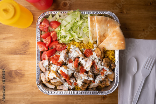 chicken over rice in aluminum bowl, new york style famous halal food photo