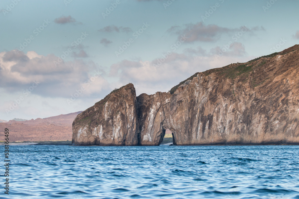 sea and rocks with an arch, San Cristobal, Galapagos Islands