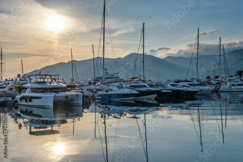 Moored yachts and motorboats at sunset