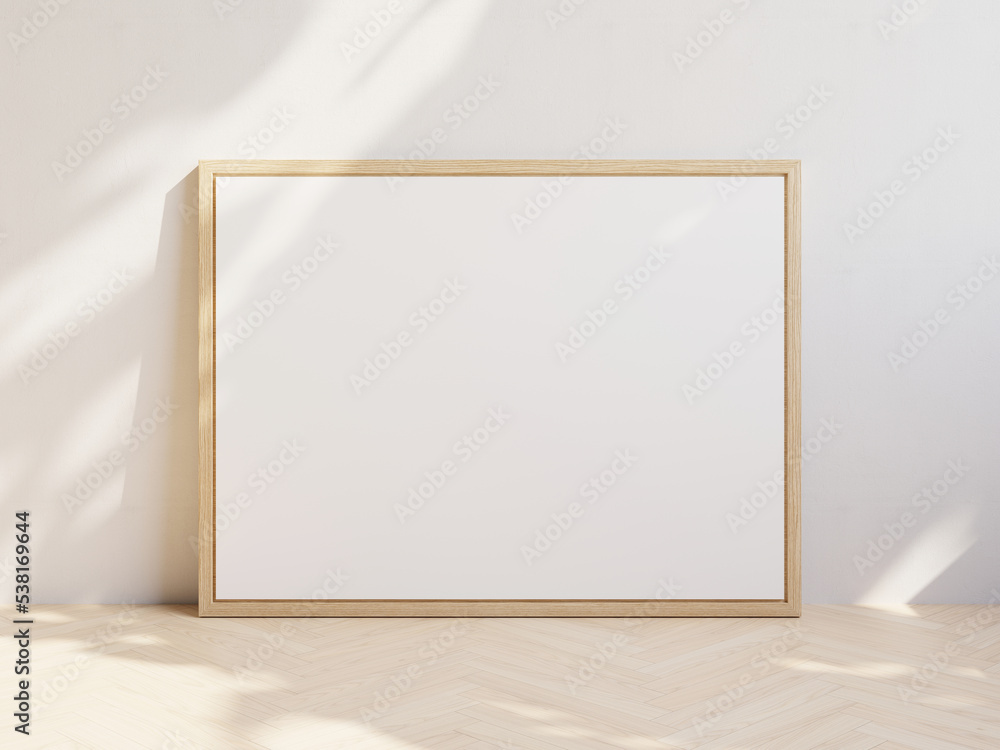 Large landscape oriented white canvas in wooden frame at wall in