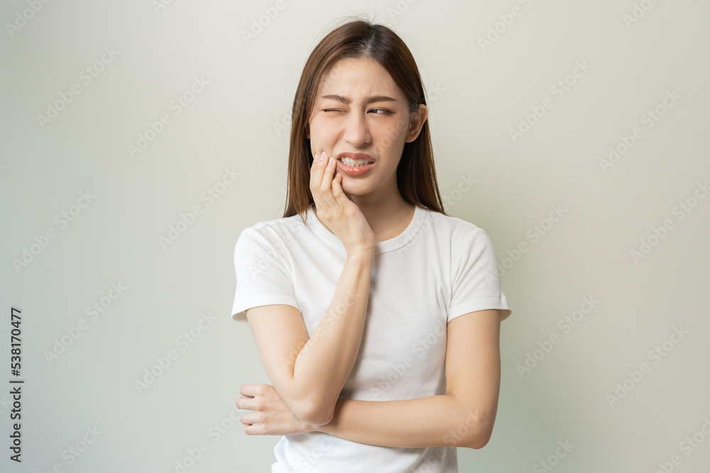 Face expression suffering from sensitive teeth and cold, asian young woman, girl feeling hurt