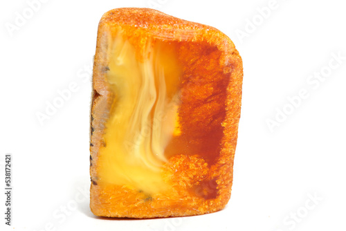 Amber with patterns on a white background. A piece of yellow sun stone. Jewelry material. Natural semi-precious mineral. Ancient fossil resin. Copal. Geology and science. landscape mineral
