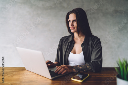 Focused woman working on laptop at table