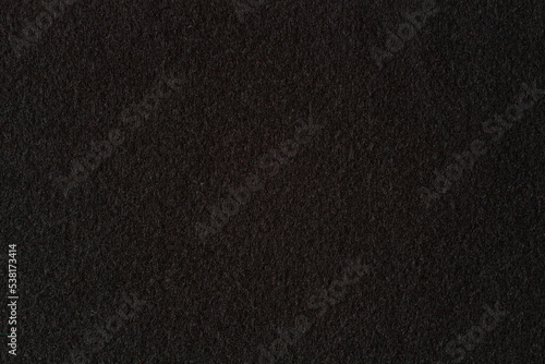 Black color felt textile fabric texture background. Top view