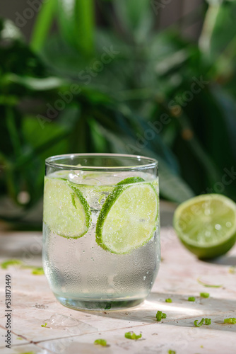 Tasty refreshing drink with lime, ice and sparkling water