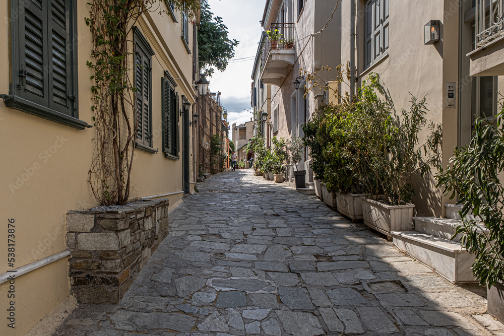 Intimate, tranquil and sunlit street located at the foothill of Acropolis, Athens, Greece.