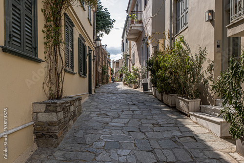 Intimate  tranquil and sunlit street located at the foothill of Acropolis  Athens  Greece.