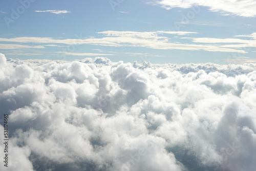 Fototapeta Naklejka Na Ścianę i Meble -  Aerial View from Airplane with City Scape below the Clouds