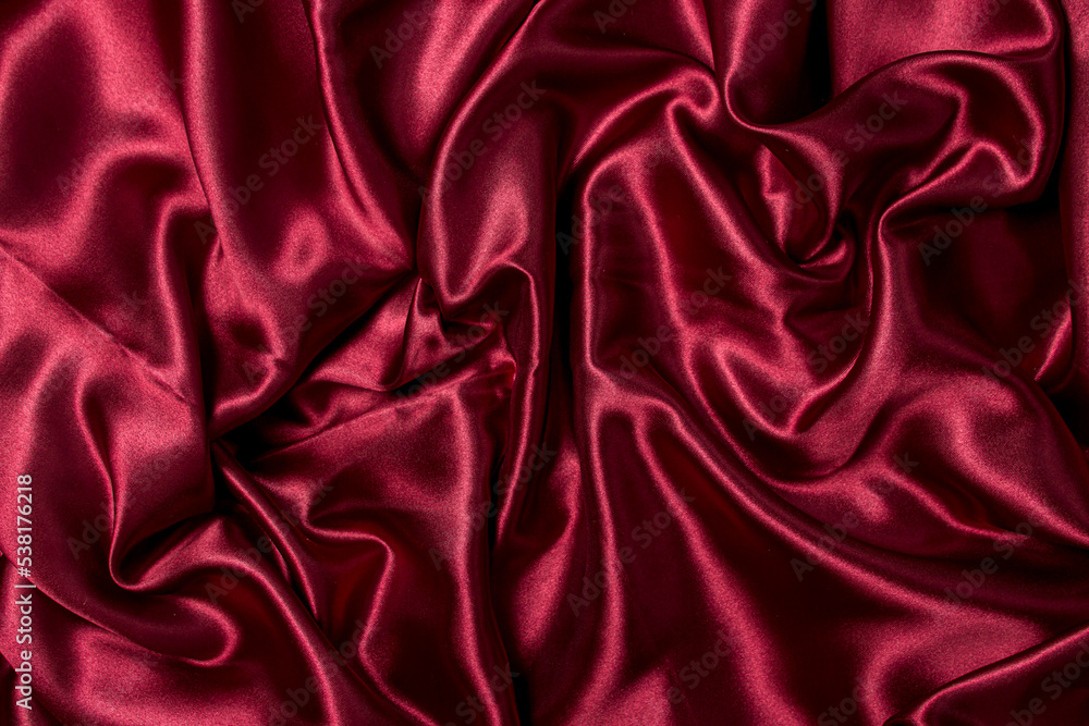 Crumpled red fabric as a background for the image. Texture of red textile material Crumpled red fabric as a background for the image. Texture of red textile material