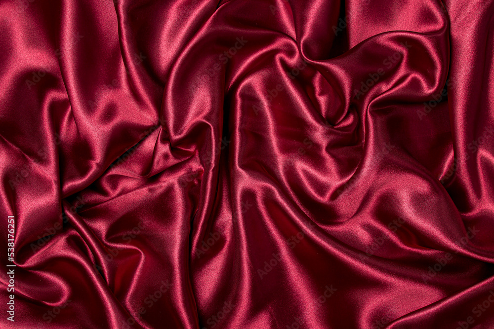 Crumpled red fabric as a background for the image. Texture of red textile material Crumpled red fabric as a background for the image. Texture of red textile material