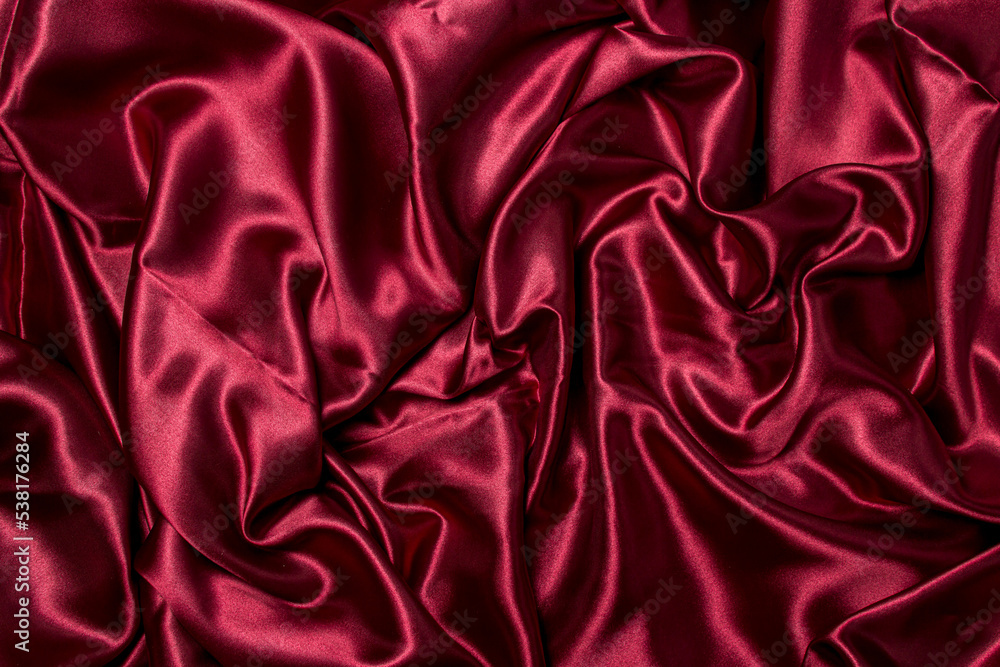 Obraz premium Crumpled red fabric as a background for the image. Texture of red textile material