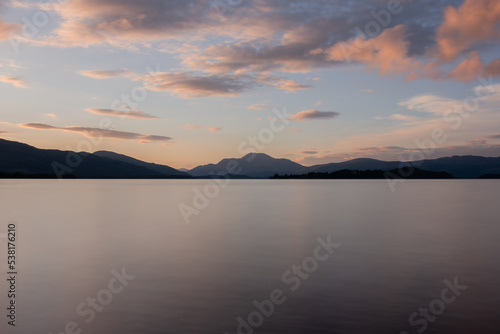 Beautiful sunset over Loch Lomond during late summer time with Ben Lomond standing high in the background