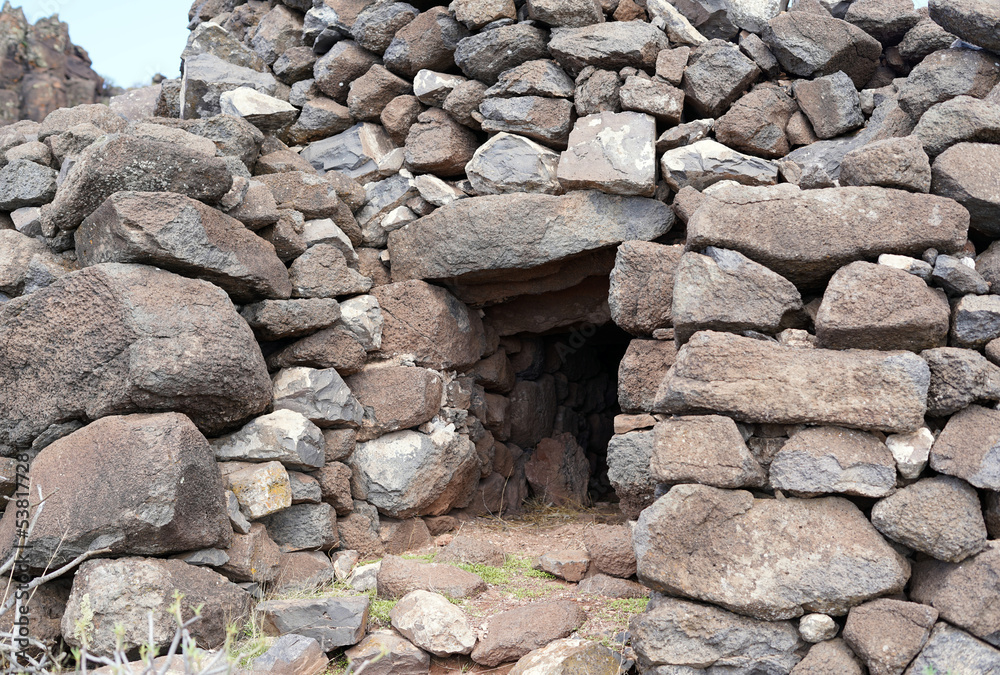 A hut built of stones. The stones are gray in color.