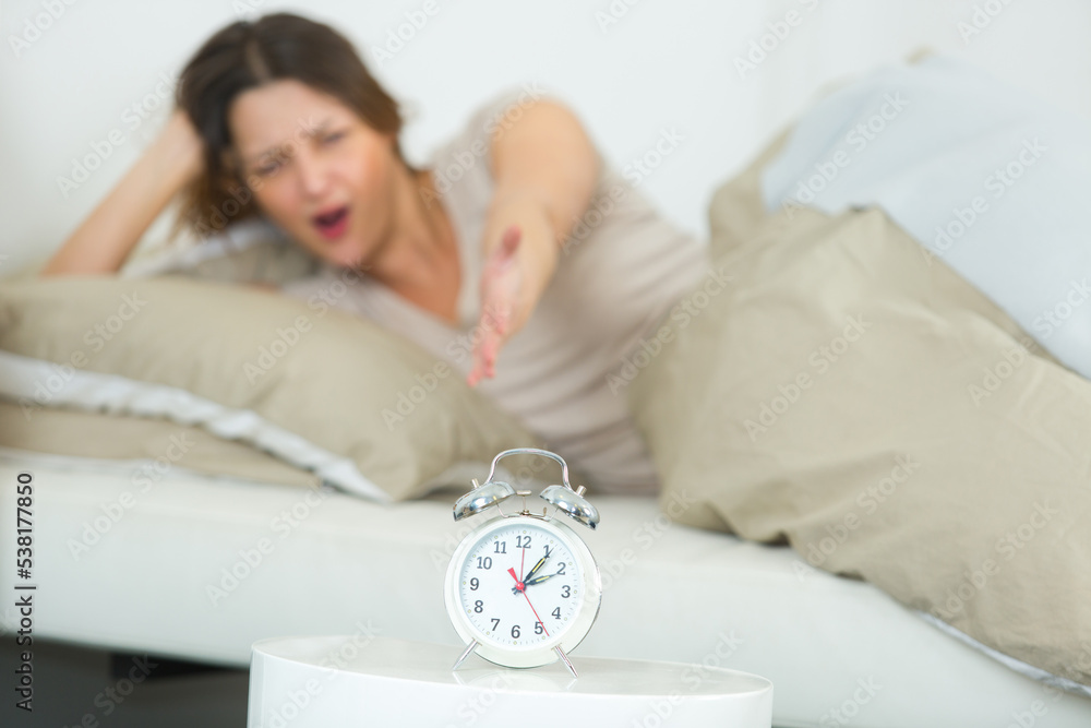 portrait of annoyed woman waking up portrait of annoyed woman waking up