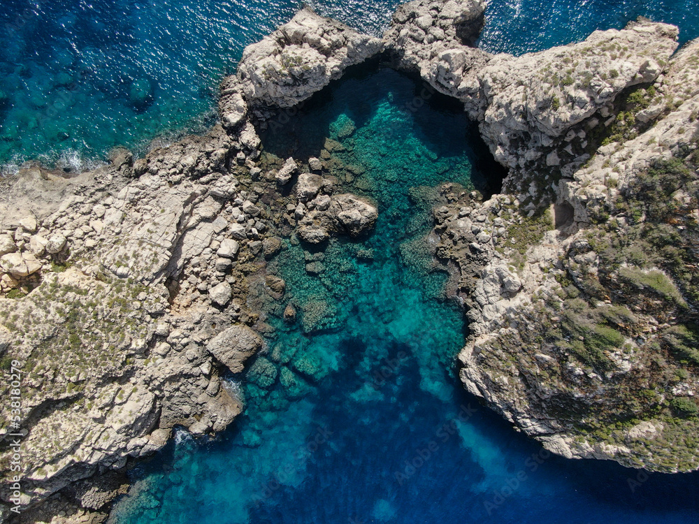 aerial view of the mediterranean sea bird's eye view of waves breaking on the rocky coast. bird´s eye of a natural pool in the middel of nature