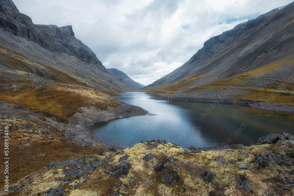 Blue northern lake in harsh mountains in north