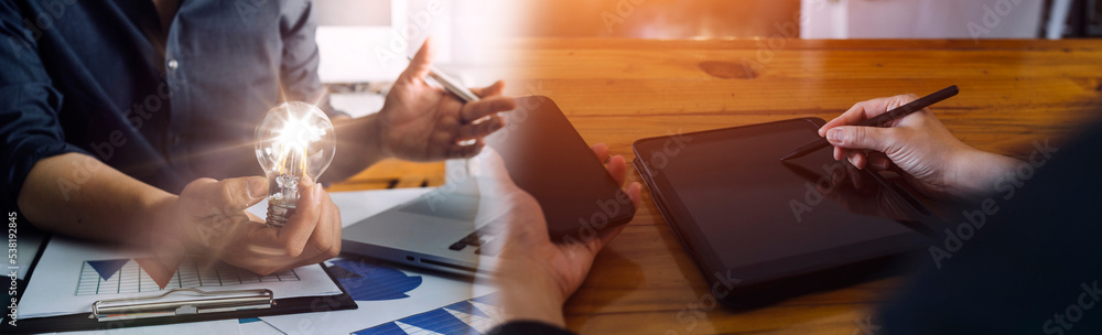 Fototapeta premium Business team present. professional investor working new start up project. Finance managers meeting.Digital tablet docking screen computer design smart phone using, in morning light