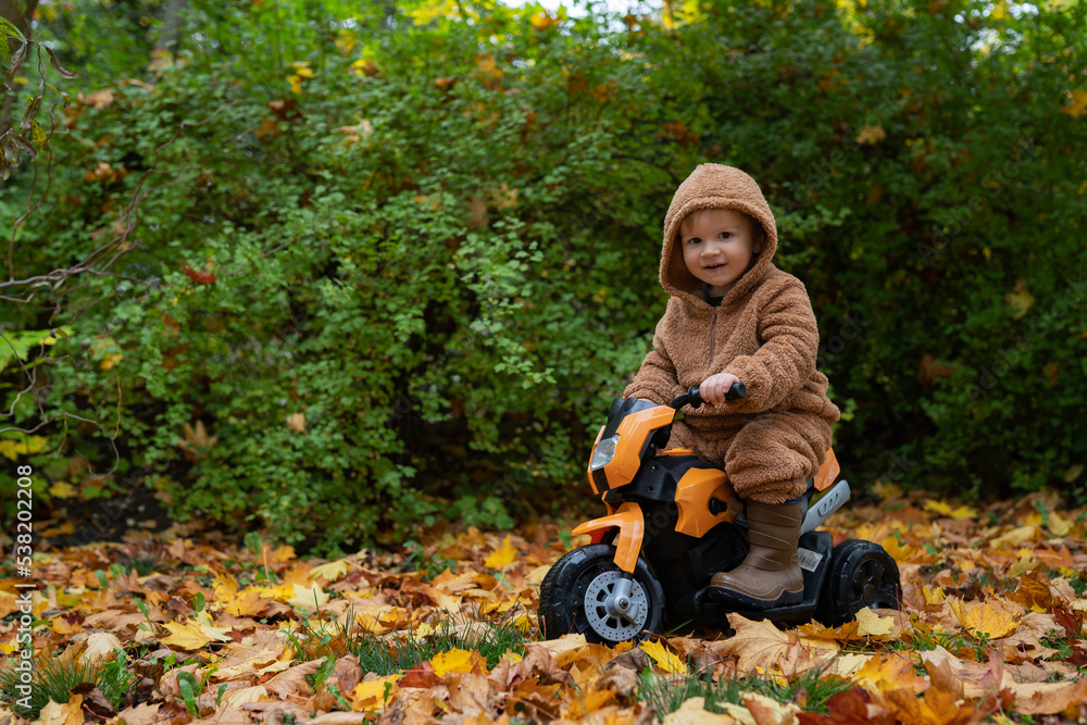 little boy sitting on a motorcycle outdoors in autumn little boy sitting on a motorcycle outdoors in autumn