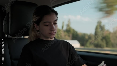 modern young woman traveling reading a book in vip vehicle