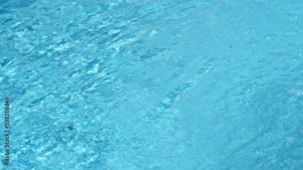 Clean blue water surface texture. Swimming pool. Side view, summer vacation, aqua relaxing background. Clean blue water surface texture. Swimming pool. Side view, summer vacation, aqua relaxing background.