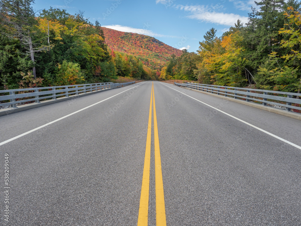 Road less traveled in the state of New Hampshire during the foliage season