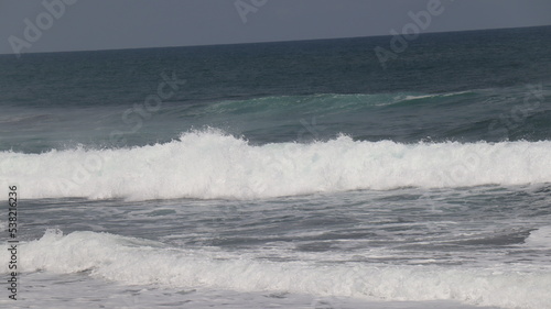 waves crashing on the beach © sugeng