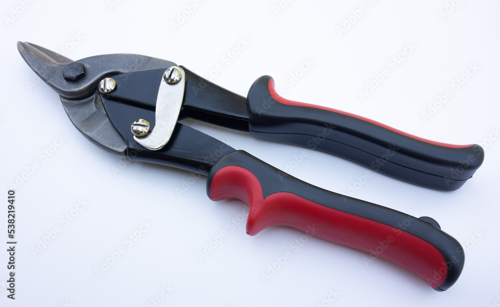 Scissors on metal on white isolate. A hand tool for cutting tin metal. Cut the iron sheet with scissors. Scissors on metal on white isolate. A hand tool for cutting tin metal. Cut the iron sheet with scissors.