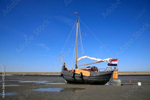 A sailboat lying on a sandbank during low tide
