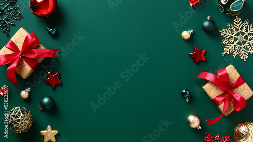 Merry Christmas and Happy New Year banner design. Xmas dark green background with gift boxes, decorations, balls. Christmas greeting card template, New Year cover, postcard mockup.