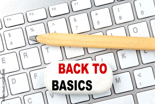 BACK TO BASICS text on eraser with pencil on keyboard