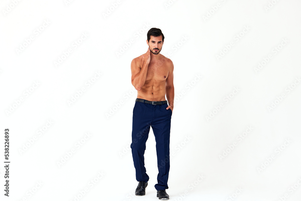 Man with bare torso and prue cubes in business pants shows full-length nude body, women's day March 8 on white isolated background copy space Man with bare torso and prue cubes in business pants shows full-length nude body, women's day March 8 on white isolated background copy space