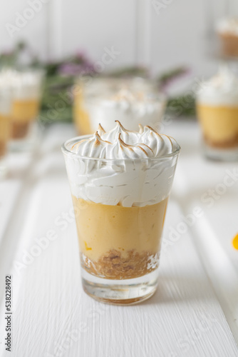 glass cups with dessert of coffee and cream with cinnamon, ordered gourmet type appetizers on a table, delicious food