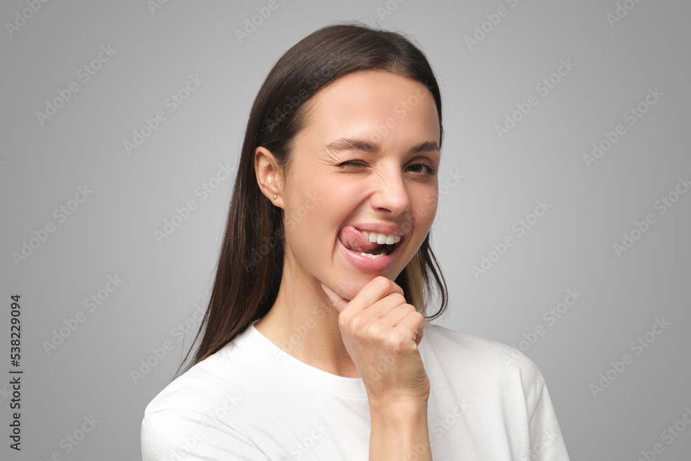 Young beautiful woman winking at camera with smile Young beautiful woman winking at camera with smile