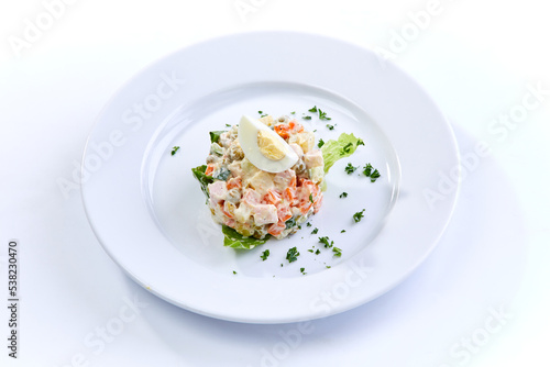 traditional russian salad on white plate