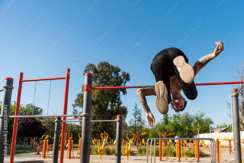 Fototapeta premium sportsman doing outdoor gymnastics, athlete, calisthenics
