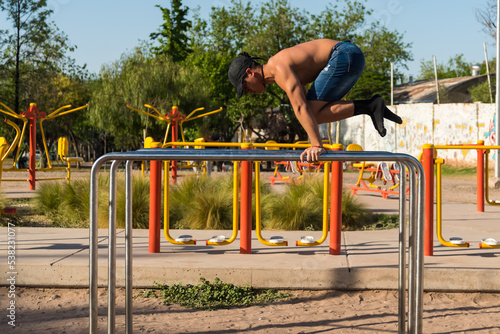 sportsman doing outdoor gymnastics, athlete, calisthenics © Jezabel