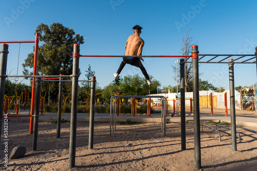 person jumping, sportsman doing outdoor gymnastics, athlete, calisthenics