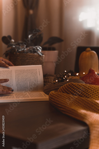 autumn photo on table with candles reading a book