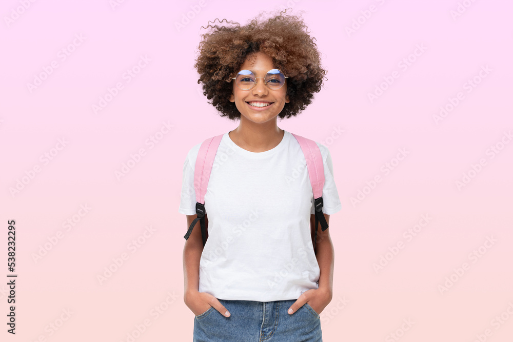 Portrait of smiling african school girl in white t-shirt, glasses and backpack, isolated on pink Portrait of smiling african school girl in white t-shirt, glasses and backpack, isolated on pink