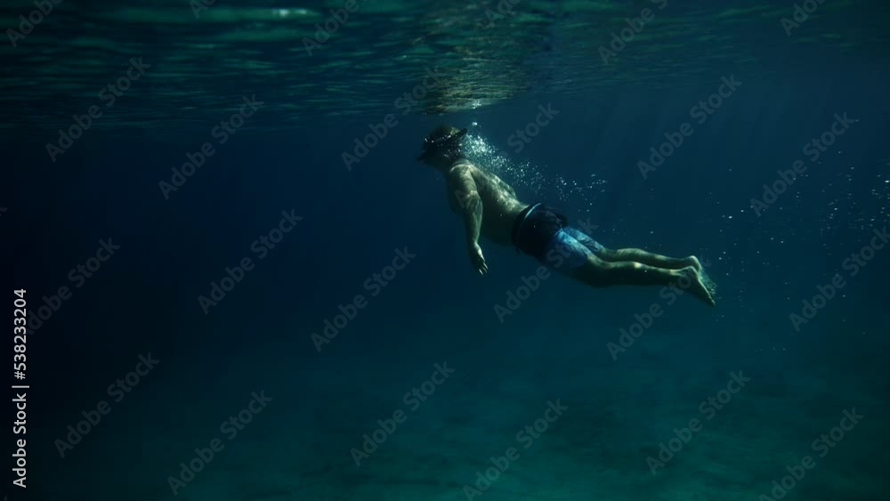 Underwater shot of guy snorkeling in crystal clean sea, Croatia Underwater shot of guy snorkeling in crystal clean sea, Croatia