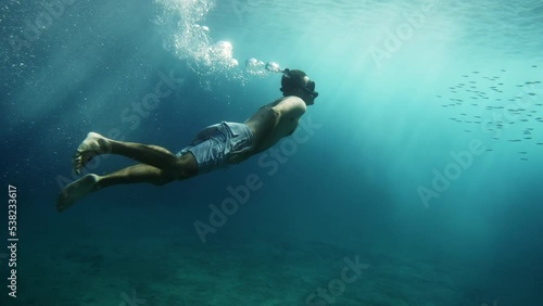 Underwater shot of guy snorkeling in crystal clean sea, Croatia
