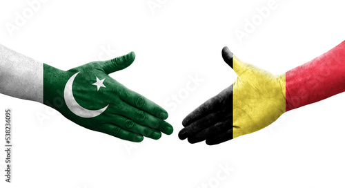 Handshake between Belgium and Pakistan flags painted on hands, isolated transparent image.