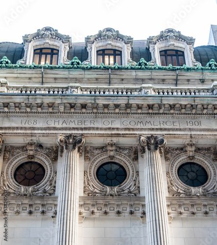 The inscription on the facade of the chamber of commerce building in the financial district of Manhattan