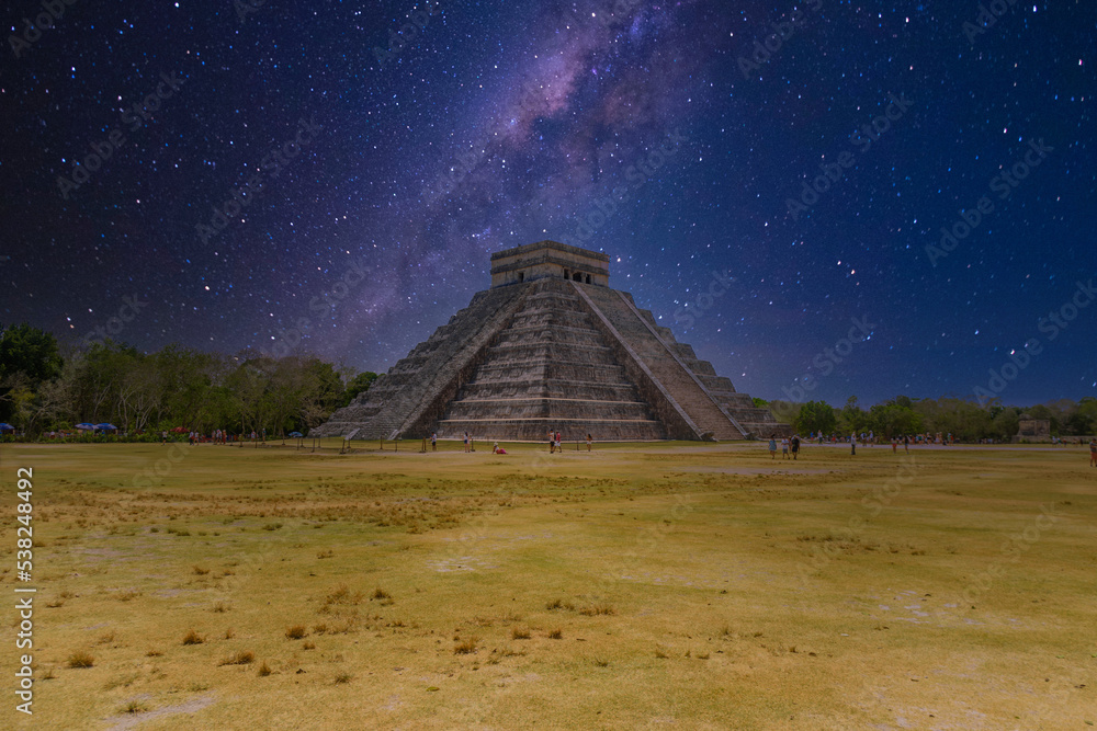 Temple Pyramid of Kukulcan El Castillo with Milky Way Galaxy stars night sky, Chichen Itza, Yucatan, Mexico, Maya civilization