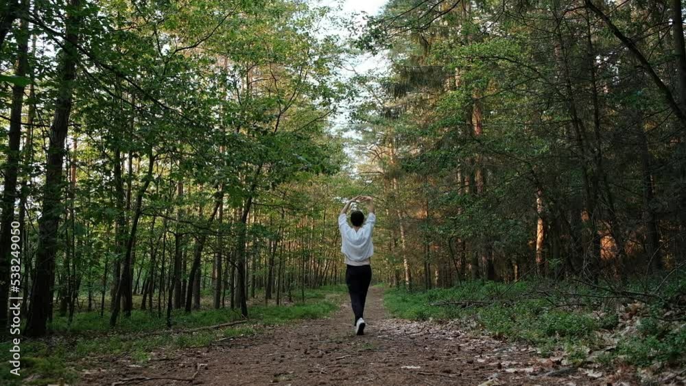 Female dancing along the path in forest, slow motion Female dancing along the path in forest, slow motion