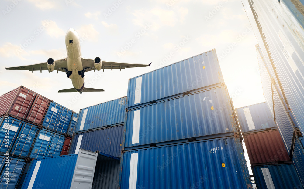 Air logistics. Cargo airplane flying above stack of logistic container.  Cargo and shipping business. Container ship for export logistic. Logistic  industry from port to port. Freight transportation. Photos | Adobe Stock