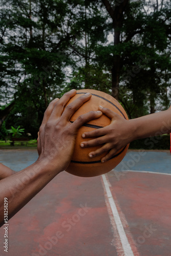 Father and son holding basketball