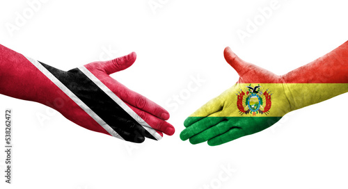 Handshake between Bolivia and Trinidad Tobago flags painted on hands, isolated transparent image.