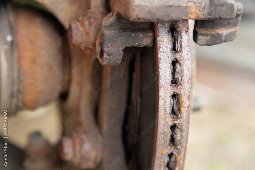 Heavy layered corrosion on old ventilated car brake rotor disc surface closeup