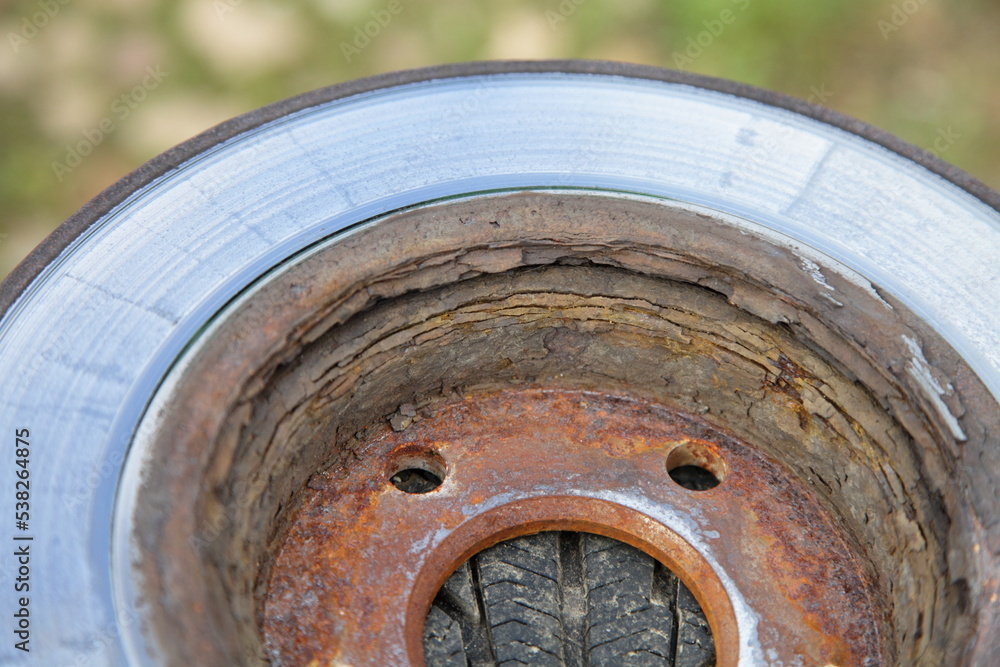 Heavy layered rust on vented car brake disk inside surface close up